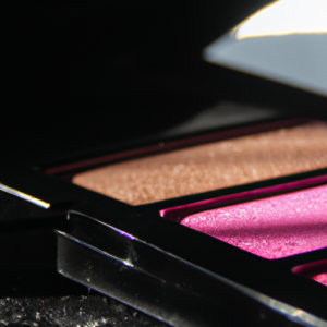 A close-up of a black and pink eyeshadow palette with a light reflecting off of it.