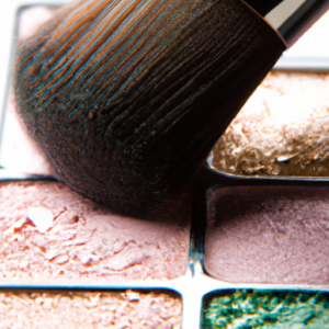 A close-up of a makeup brush with various shades of eye shadow on it.