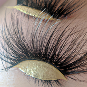 A close-up of a pair of eyelashes with a light shimmery effect.