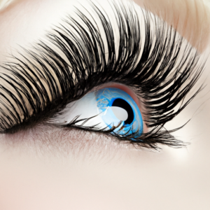 A vivid blue eye with a set of dramatic false eyelashes.