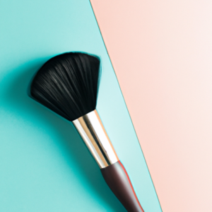 A makeup brush with smooth, curved bristles against a bright, color-blocked background.