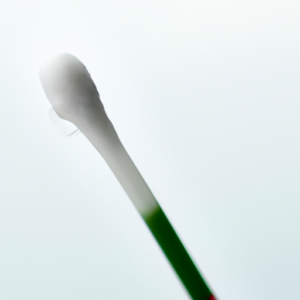 A close-up of a cotton swab dabbed in remover, with a focus on the tip.