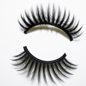 A pair of false eyelashes lying on a white background.