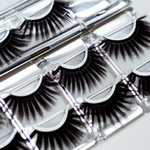 A close-up of a set of magnetic eyelashes, with a glossy metallic finish.