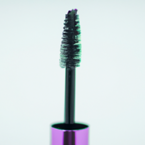 A close-up shot of a colorful mascara wand with a glossy finish.